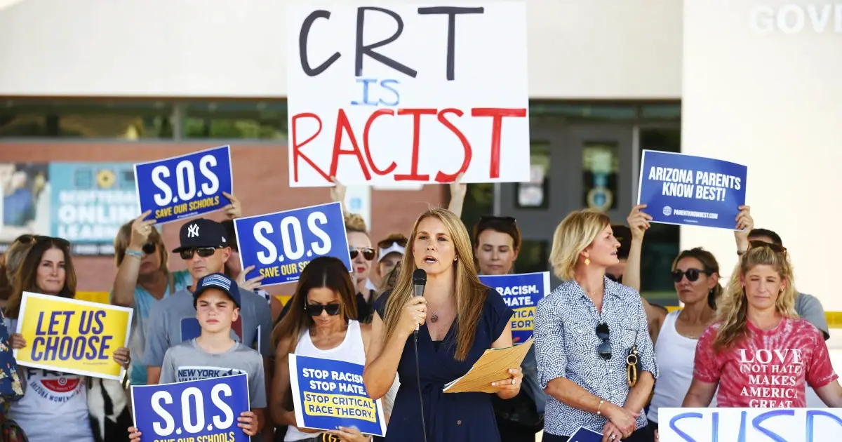 A photo of protesters holding signs opposing critical race theory.
